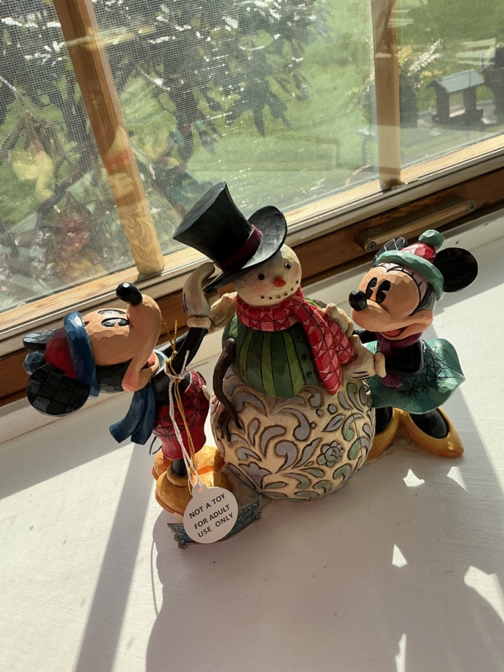 Jim Shore Disney Traditions figurine titled "Dressing Up For The Holidays.